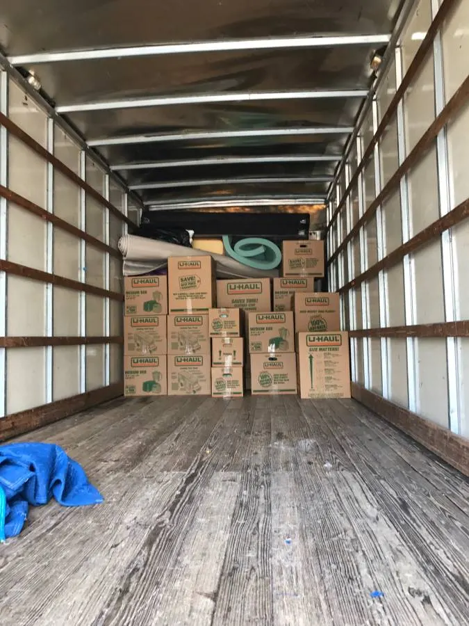 Inside the Royal Moving truck with boxes stacked at the front