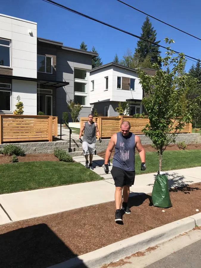 A mover walking up the path at a row of townhouses