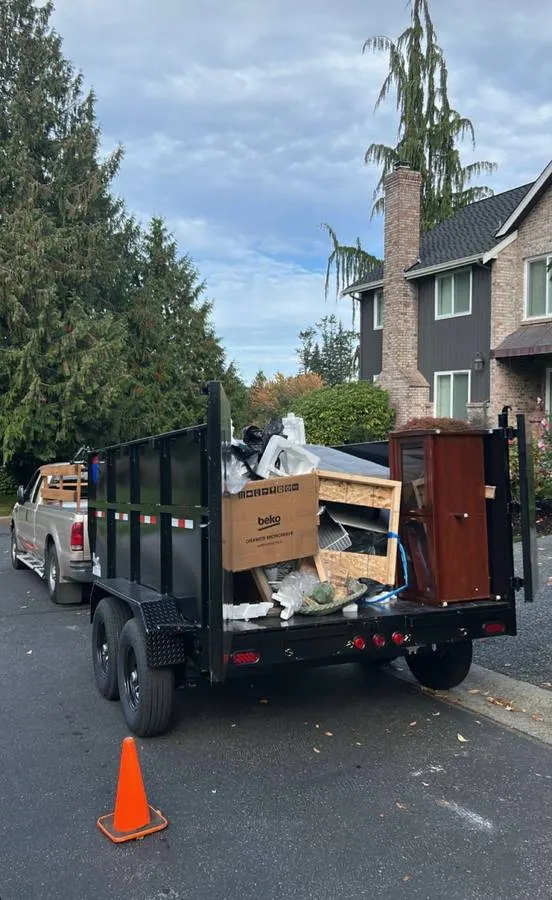A trailer loaded with old furniture and junk