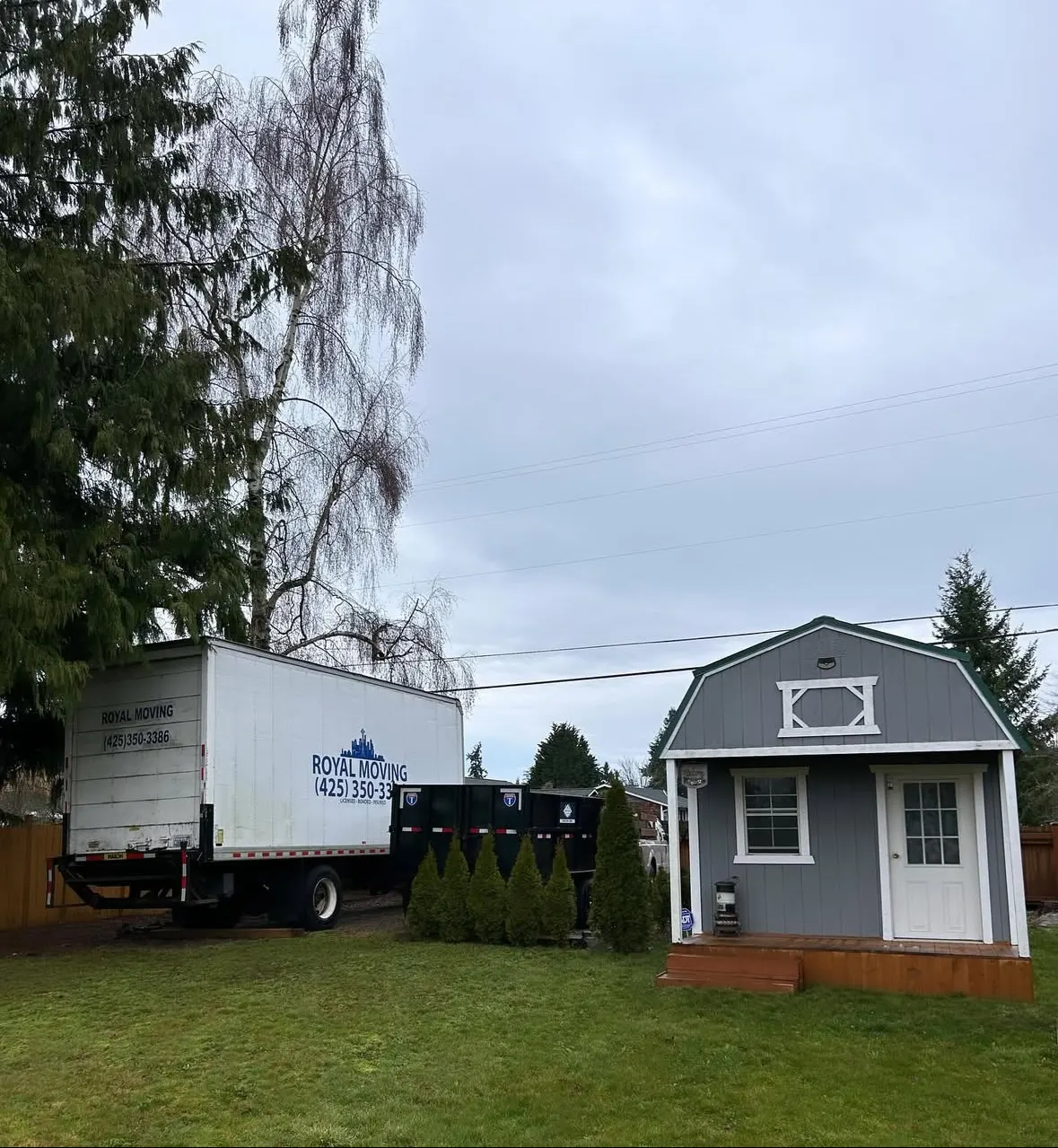 The Royal Moving truck parked beside a storage building