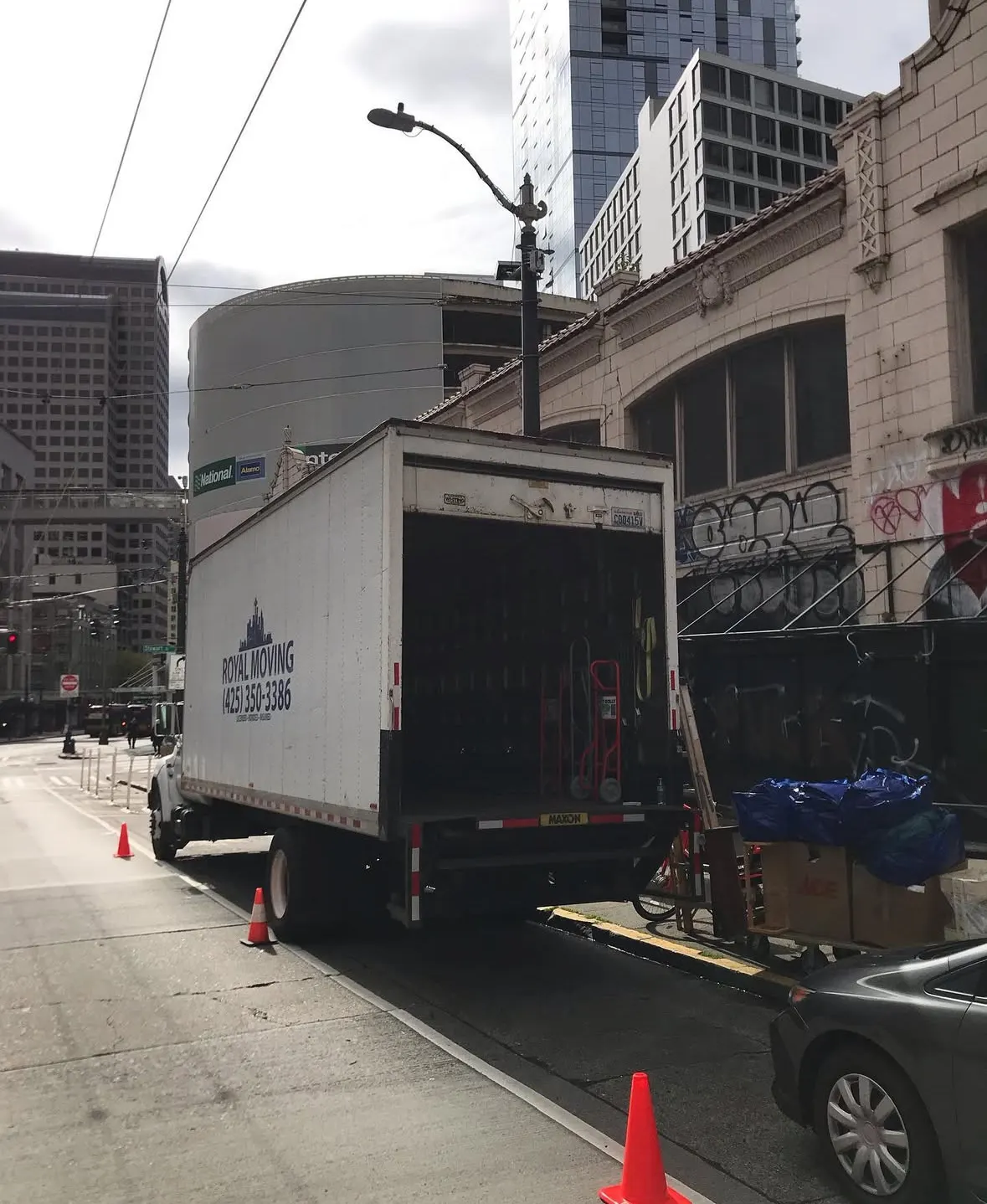 The truck parked on a downtown street beside older brick buildings