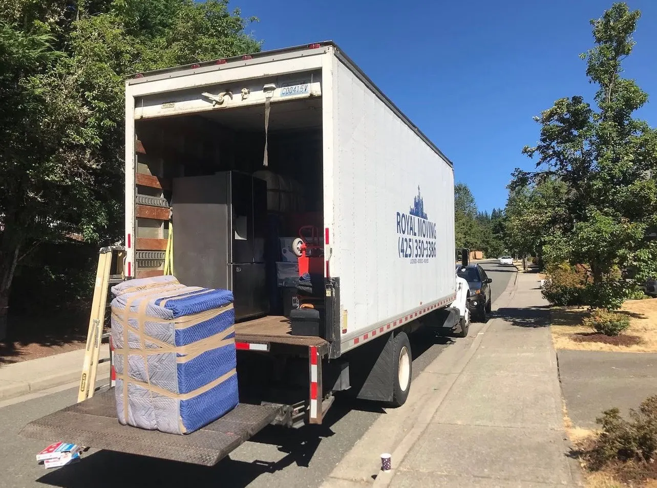 The Royal Moving truck with its ramp down and furniture on the liftgate