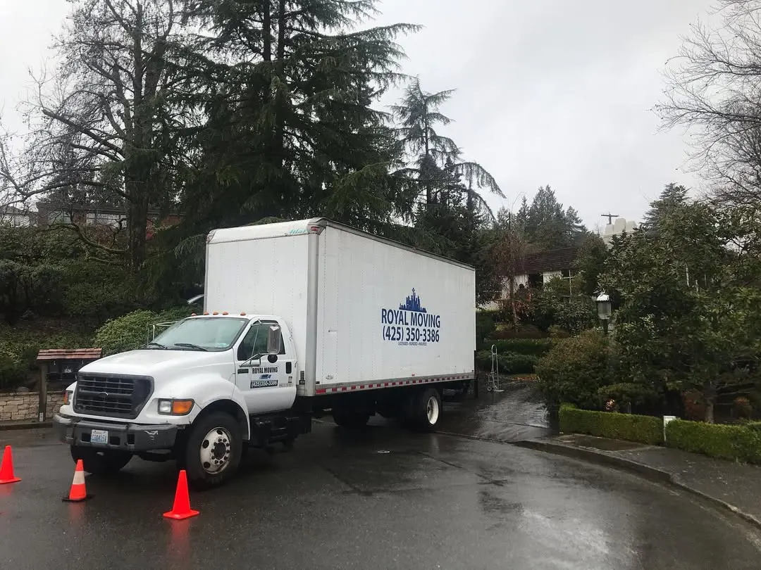 The Royal Moving truck parked on a wet residential street
